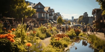 a group of people walking along a canal with flowers and trees