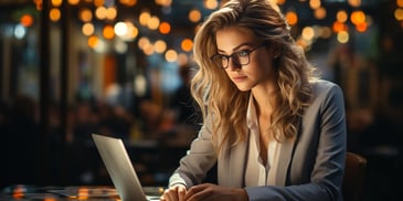 a person sitting at a desk with a laptop