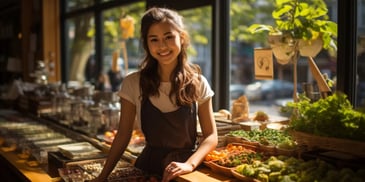 a person standing behind a counter with food