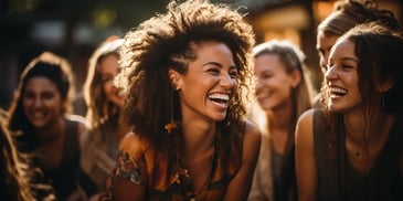 a person laughing with other women in the background