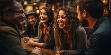 a group of people laughing at a table