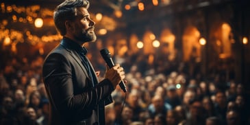 a person holding a microphone in front of a crowd