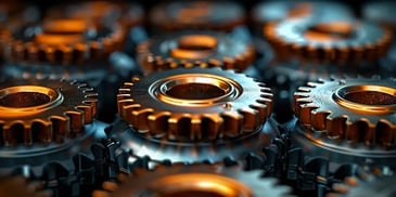 Close-up of interlocking metal gears with a bronze finish, arranged in a pattern, illuminated by soft lighting.