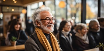 a person with glasses and a beard smiling