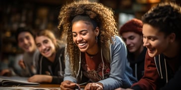 a person smiling with curly hair and a group of people behind her