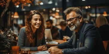 a person and person sitting at a table